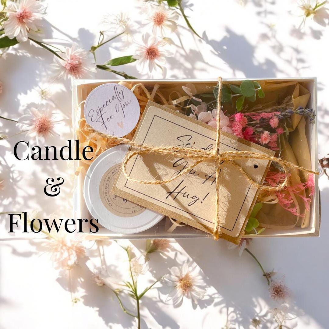 a box of candles and flowers on a table gift box
