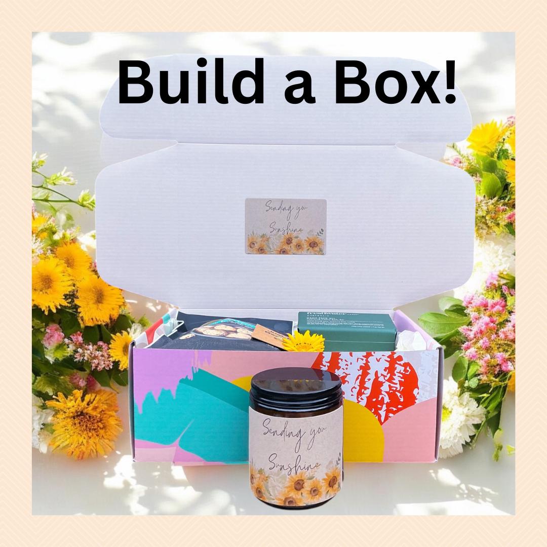 Customizable &#39;Build a Box&#39; gift set with a theme, featuring a vibrant and colorful box. Includes options to personalize with items like a candle, pampering essentials, and uplifting gifts, beautifully presented for any occasion.