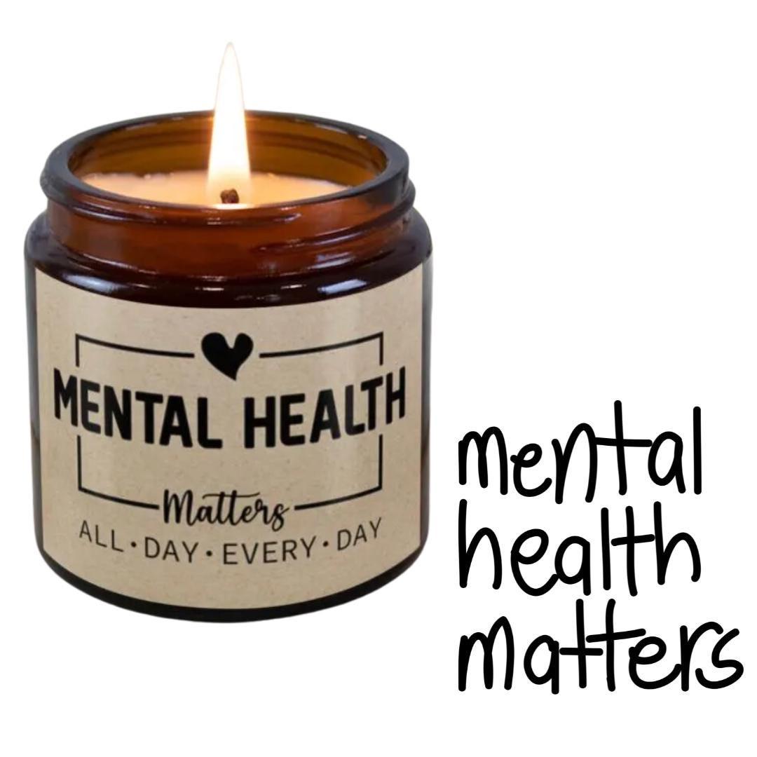 Amber glass jar candle with a personalized message label, mental health matters